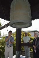 原爆投下時刻に合わせて鐘を突き、平和を願う参加者＝小松島市松島町の光善寺