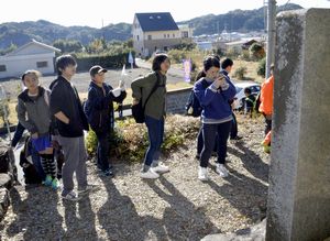 津波の被害状況など刻んだ石碑を見学する徳島文理大生ら＝海陽町浅川