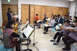 ギター演奏に合わせて童謡などを歌うお年寄りら＝徳島市の昭和コミュニティセンター