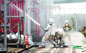 石油の流出を想定した火災消防訓練に取り組む参加者=徳島市の新日本理化徳島工場