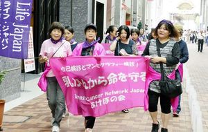 前回のイベントで、がん検診の重要性を訴えながら歩く乳がん経験者ら＝２０１６年１０月１日、徳島市の東新町商店街