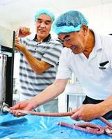 シカ肉の生ソーセージを製造する参加者=石井町の徳島大生物資源産業学部農場