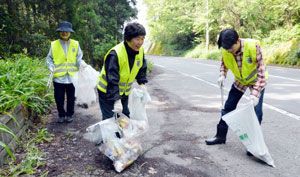 国道沿いに捨てられたごみを拾い集める「空き缶十字群」のメンバー＝佐那河内村下