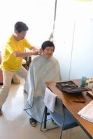 高齢者の髪を切る理容師。５０年続くボランティア活動だ＝阿南市畭町の福寿荘
