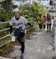 チェックポイントを目指して高台の階段を上る参加者＝海陽町鞆浦